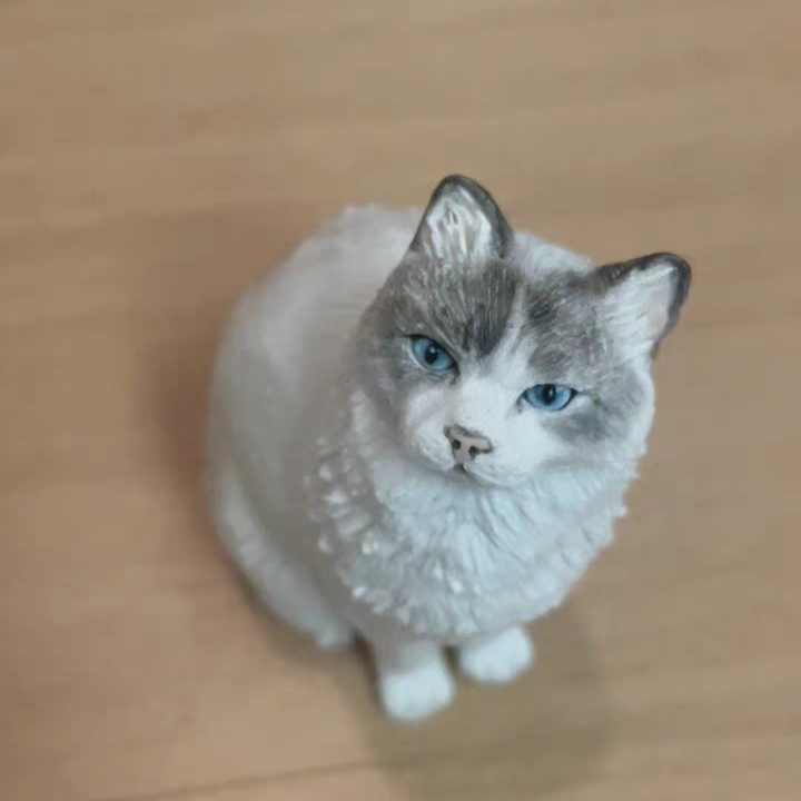 Soft ceramic sculpture of a cute white cat sitting on the ground