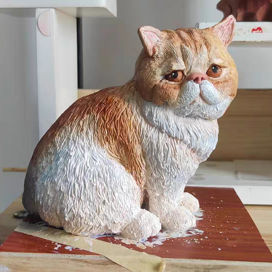 A chubby cute yellow and white cat soft ceramic sculpture