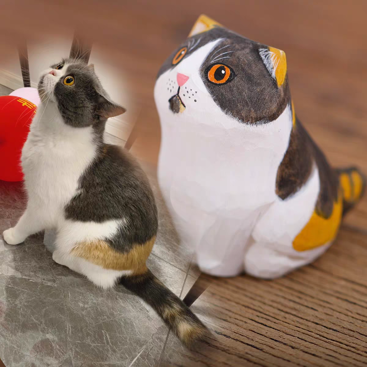 A fluffy, cute cat with a little wooden statue exactly like her next to it