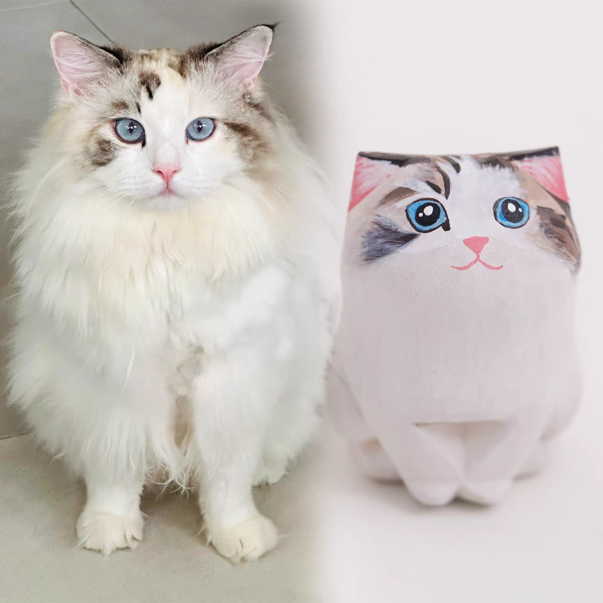 A fluffy, cute cat with a little wooden statue exactly like her next to it