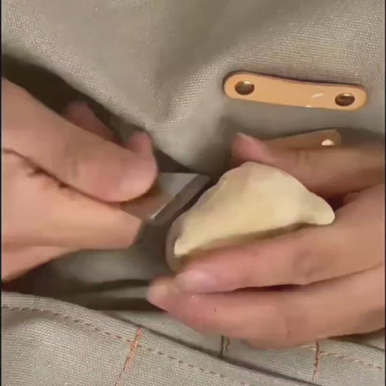 A man carving a wooden kitten, from the carving to the coloring, the finished product is lifelike