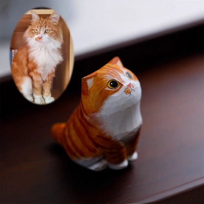 A fluffy, cute cat with a little wooden statue exactly like her next to it
